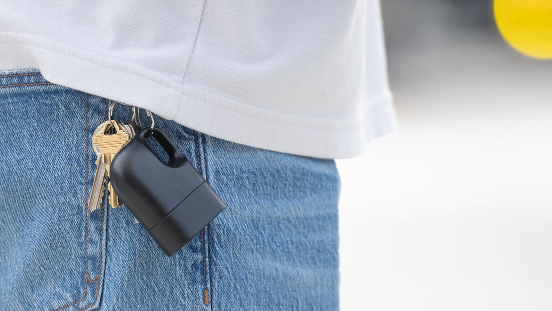 Nove naloxone carry case clipped to a keychain on a person’s jeans