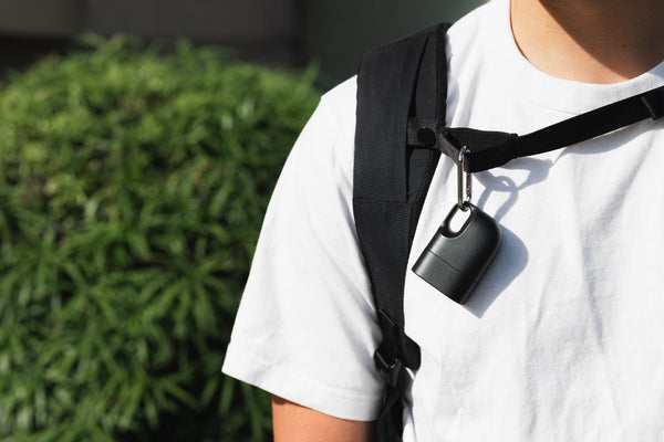 Nove case clipped to a backpack strap